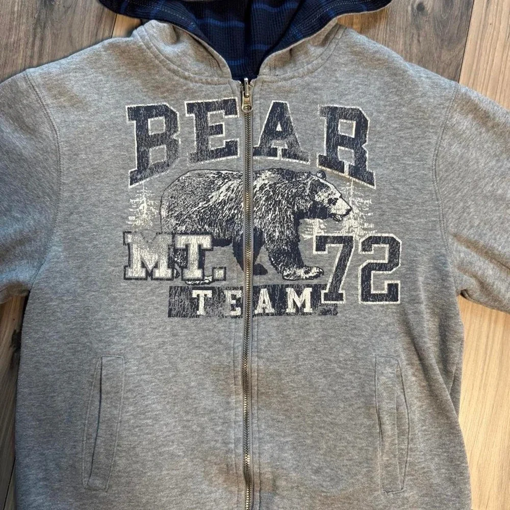 Heavy-duty, double-lined reversible gray zip-up hoodie featuring a bear